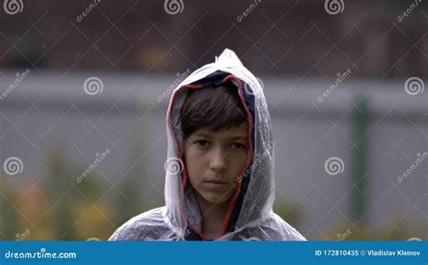 Sad Boy Standing In A Raincoat In The Rain Stock Image Image Of