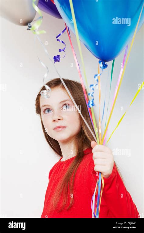 Girl Holding Balloons Stock Photo Alamy