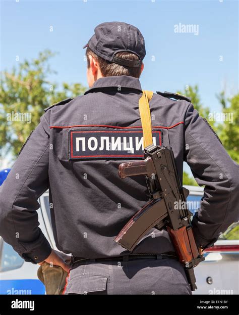 Russian Policeman In Uniform With Automatic Rifle Text In Russian