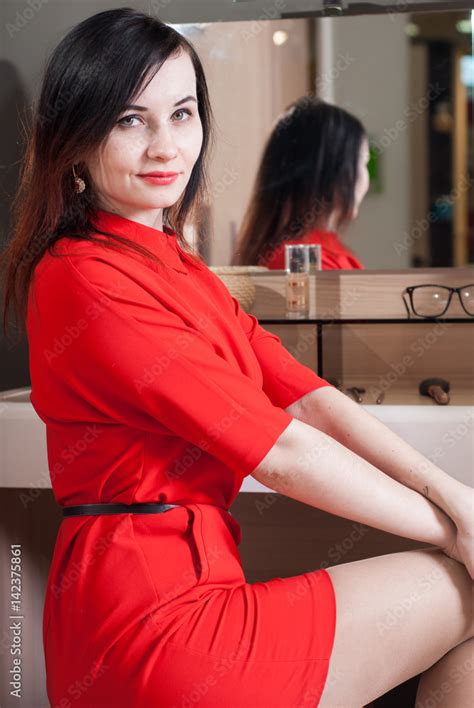 woman in short red dress sitting stock foto adobe stock