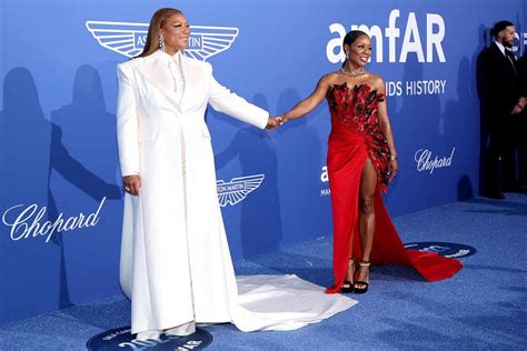 Queen Latifah And Eboni Nichols Hold Hands On Red Carpet At Amfar