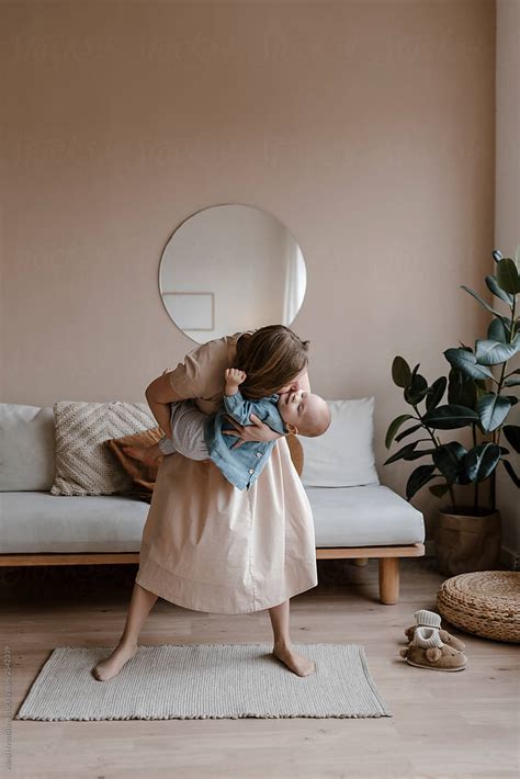 Happy Mom Holding Her Little Daughter By Hands And Kissing By Stocksy Contributor Alina