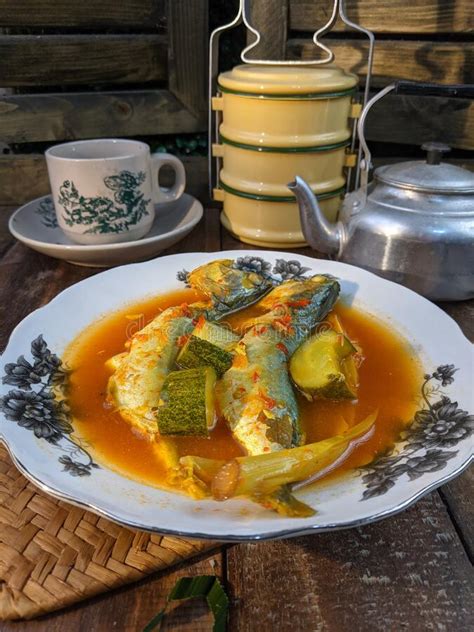 A Plate Of Fish Cookes In Spicy Sour Sauce Called Asam Pedas Stock