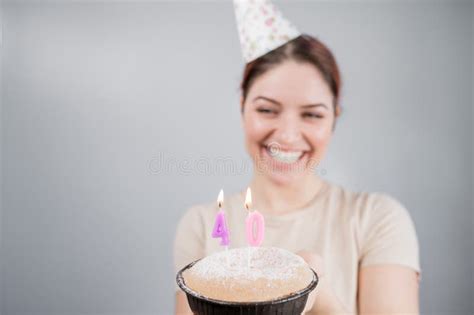 the happy woman makes a wish and blows out the candles on the 40th birthday cake girl
