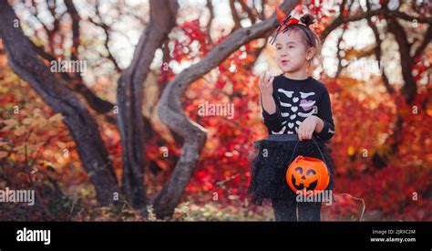 Young Girl In Black Costume Goes Trick Or Treating Little Witch Kids