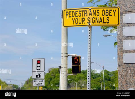 Street Signs Directing Pedestrians To Obey Traffic Signals Stock Photo