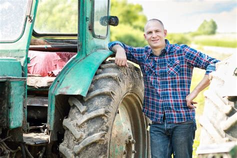 Farmer Driving Tractor In Countryside Stock Photo Image Of Harvest