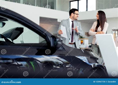 Sales Manager At A Showroom Car Is Worth To The Buyer Stock Image