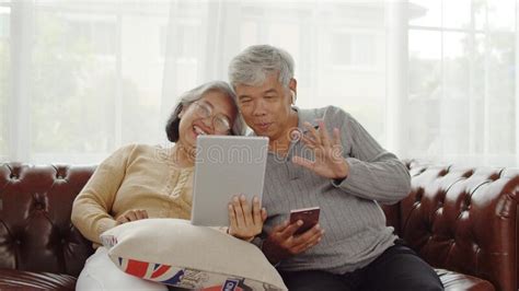 Senior Couple Making Video Call With Happiness At Home Stock Image