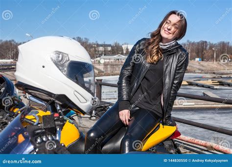 woman motorcyclist waiting train at railroad station travel under own power after bike freight