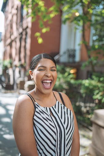 Beautiful Plus Size Dominican Woman In Usa Ecstatic And Laughing Stock