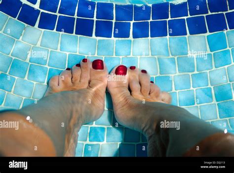 Womans Feet With Red Painted Toenails On Blue Swimming Pool Tiles Under Water Stock Photo Alamy