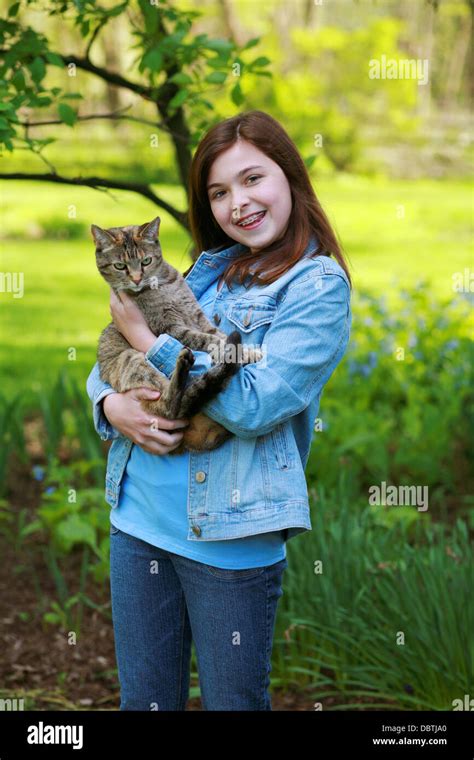 Beautiful Brunette Girl Outside Holding A Cat Stock Photo Alamy