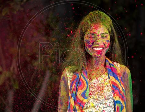 Image Of Young Indian Girl Happily Playing With Colors Celebrating Holi