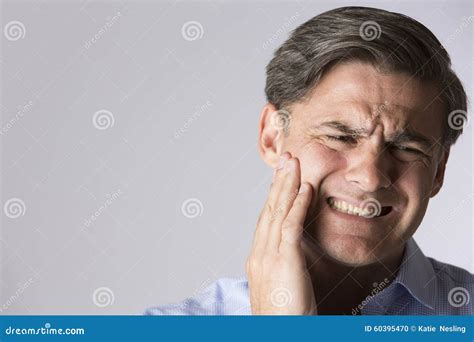 Studio Portrait Of Man Suffering With Toothache Stock Photo Image Of