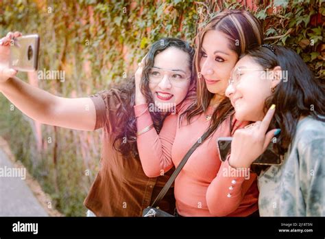 Three Girls Taking Selfie In The Street Looking Happy Because They Love Each Other So Much