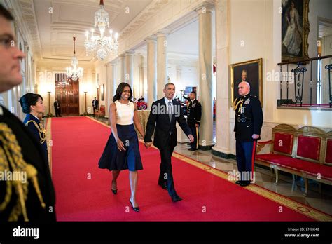 President Barack Obama and First Lady Michelle Obama walk down the