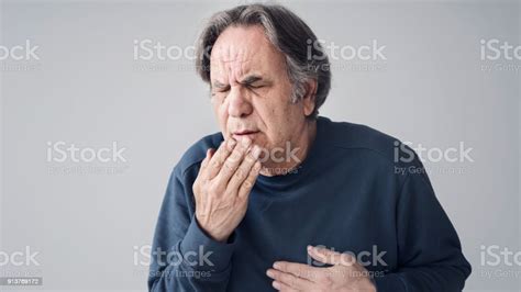 Elderly Man Coughing On Isolated Background Stock Photo Download