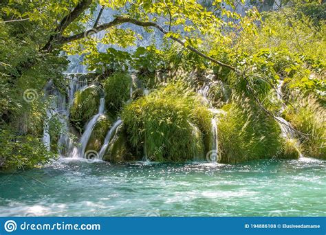 Waterfalls Flowing Into Turquoise Lake Stock Photo Image Of Lush
