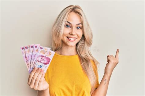 Beautiful Caucasian Blonde Girl Holding 50 Mexican Pesos Banknotes