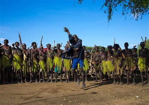 Toposa Tribe Man Dancing In Front Of Women During A Ceremony
