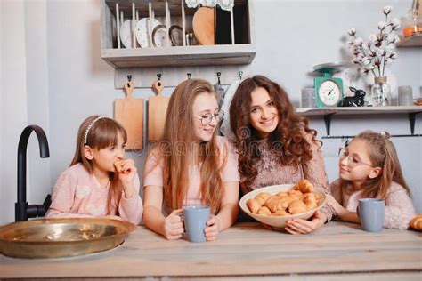 cute sisters standing in a kitchen and eats buns stock image image of happy sisters 227401081