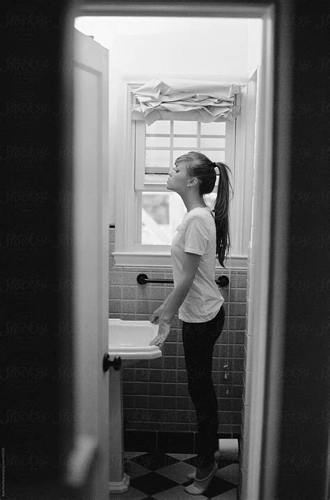 Woman Standing In Bathroom By Stocksy Contributor Ryan Muirhead Stocksy