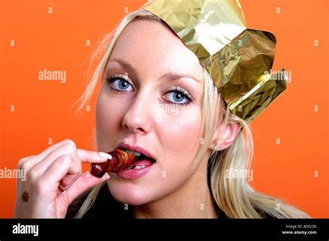 Young Woman Eating A Sausage Model Released Stock Photo Alamy