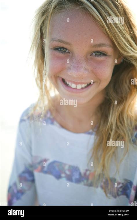 Cute Teenage Blond Girl Enjoys A Day At The Beach With Surf Board Stock