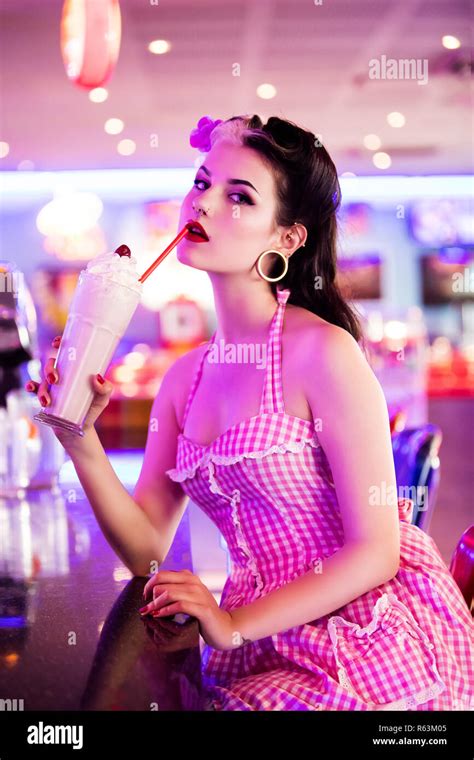 Portrait Of A Young Pin Up Profile Delicately Drinking A Milkshake