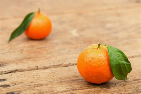 Fresh Mandarin Oranges Fruit With Leaves In Old Wooden Table Stock