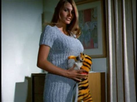 A Woman Is Holding A Stuffed Tiger In Her Hand While Standing Next To A