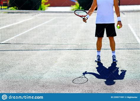 Mature Handsome Man Playing Tennis On Tennis Court At Sunny Day Stock