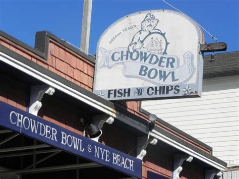The Sign For Chowder Bowl And Chips Is Hanging From The Building