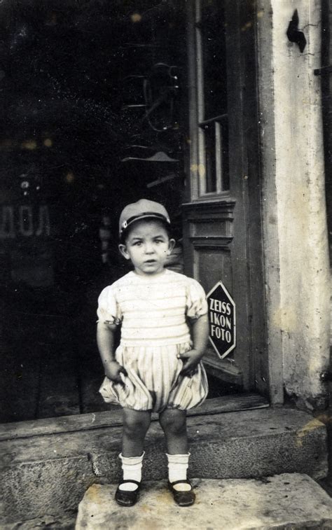 A Bulgarian Jewish Child Stands In The Doorway Of A Photography Studio