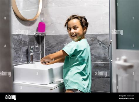 Little Girl Is Washing Her Hands In The Bathroom Stock Photo Alamy