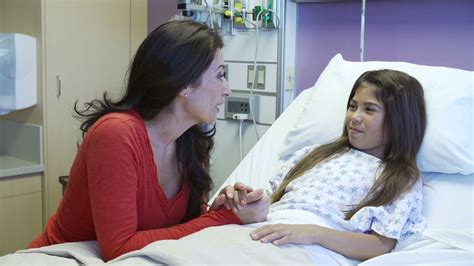 Mother And Daughter With Female Nurse In Hospital Room Stock Video