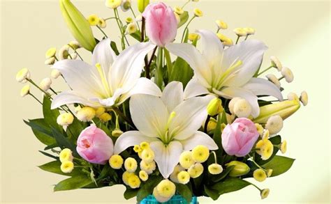 A Blue Vase Filled With White And Pink Flowers