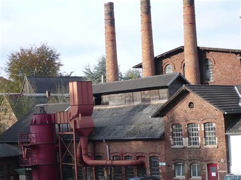 An Old Brick Building With Two Large Chimneys