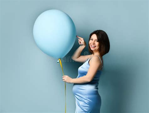 Pregnant Lady In Blue Silk Dress Or Nightie She Is Smiling Holding Balloon By Yellow Ribbon