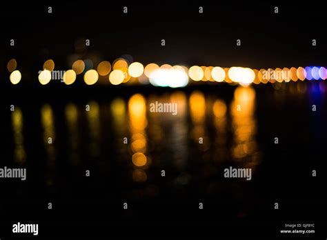 Beautiful Blurred City Lights With Bokeh Effect Reflected On Water
