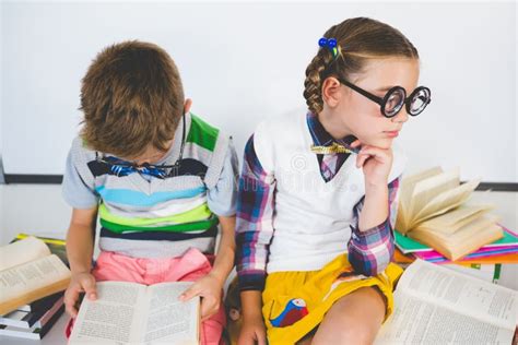 School Kids Reading Book In Classroom Stock Photo Image Of