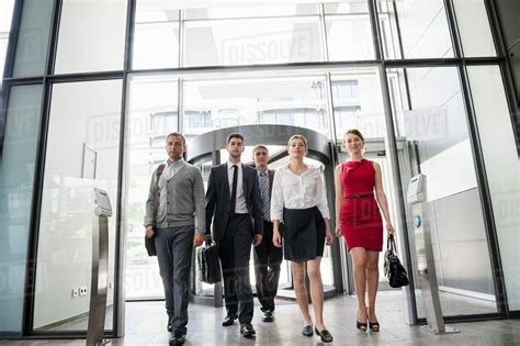 Group Of Business People Walking Into Glass Office Building Stock