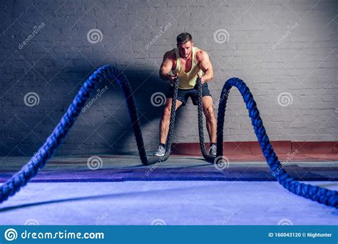 Young And Handsome Male Athlete Man Doing Exercises For The Muscles Of