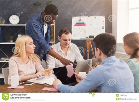 Discussing your salary information with your coworkers can lead to serious problems at work. Company Coworkers Discussing Ideas In Office Stock Photo ...