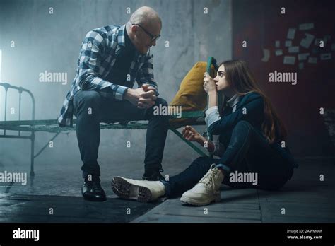 Maniac Kidnapper And Victim Handcuffed To The Bed Stock Photo Alamy