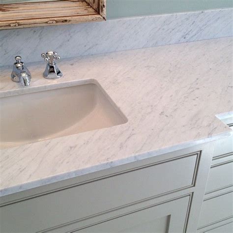 Carrara Marble Countertops Pair With A Polished Chrome Hot And Cold