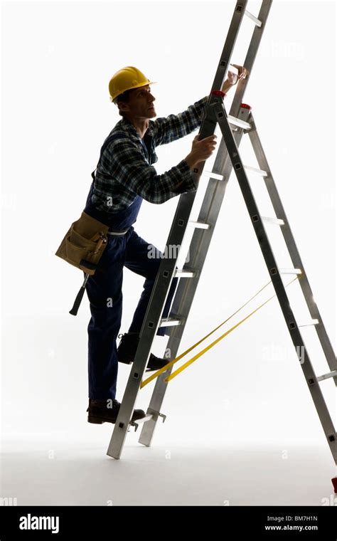 A Construction Worker Climbing A Ladder Stock Photo Alamy