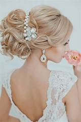 Rejuvenate the classic chignon by twisting back smaller sections and securing with a large flower for the maximum impact. 21 Glamorous Wedding Updos for 2020 - Pretty Designs