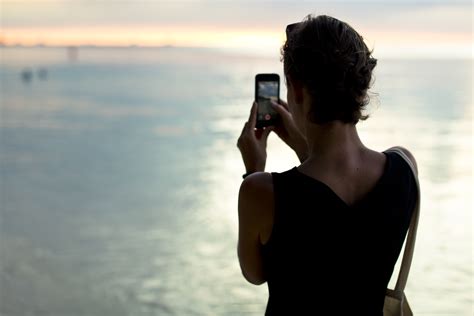 Free Images Smartphone Hand Man Beach Sea Water Ocean Woman Sunset Sunlight Morning